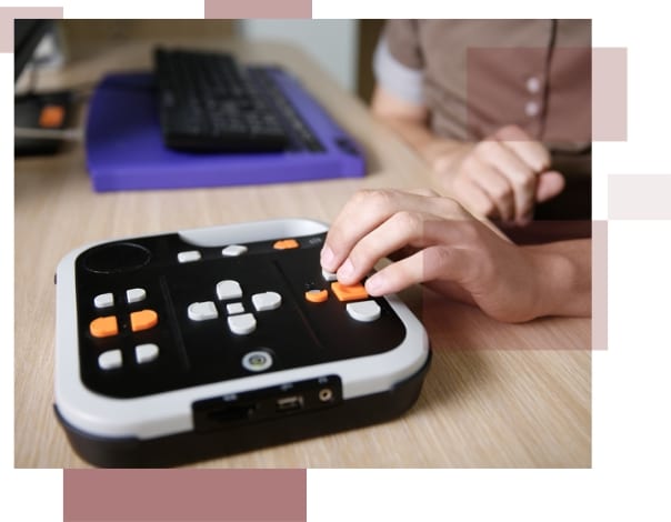 A hand typing on a visual impairment aid