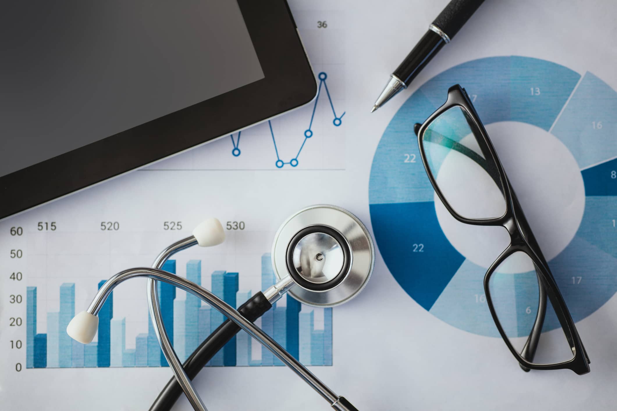 A stethoscope on a table with healthcare digital marketing strategies